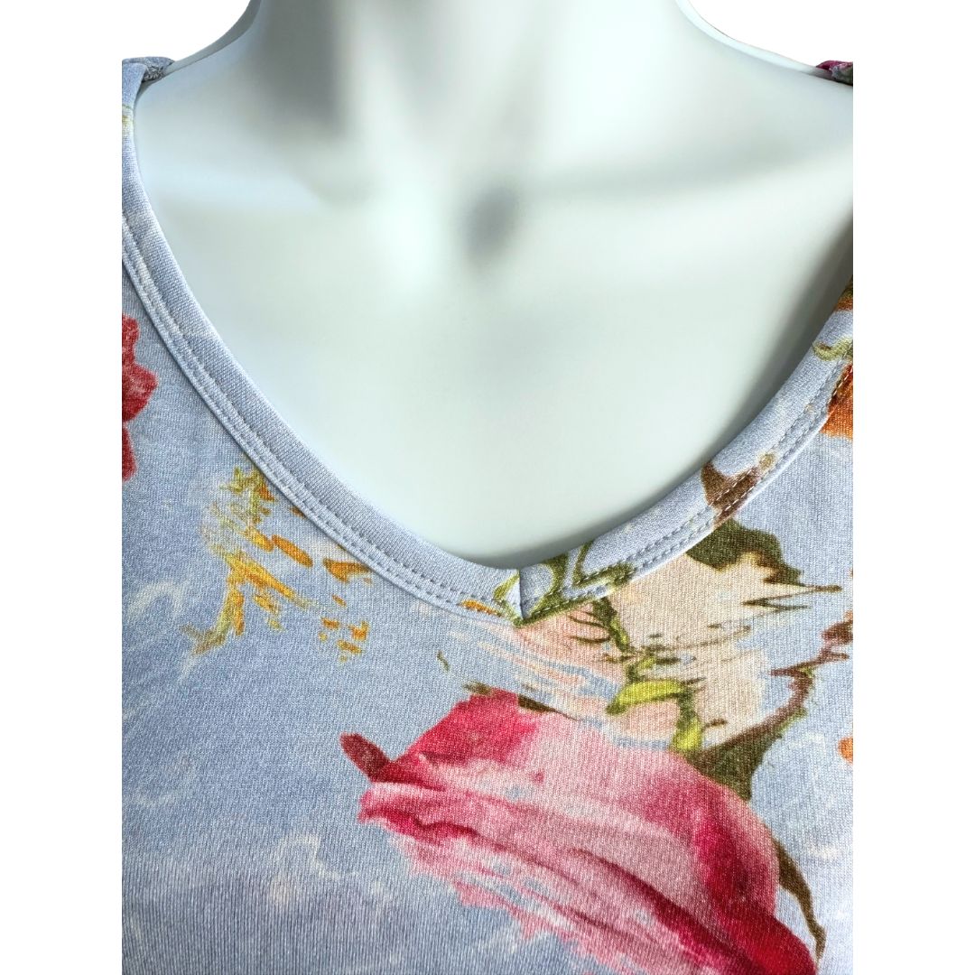 Blue Maxi length dress with large pink and red floral pattern. Soft material. Elbow length sleeves. V neck showcased.