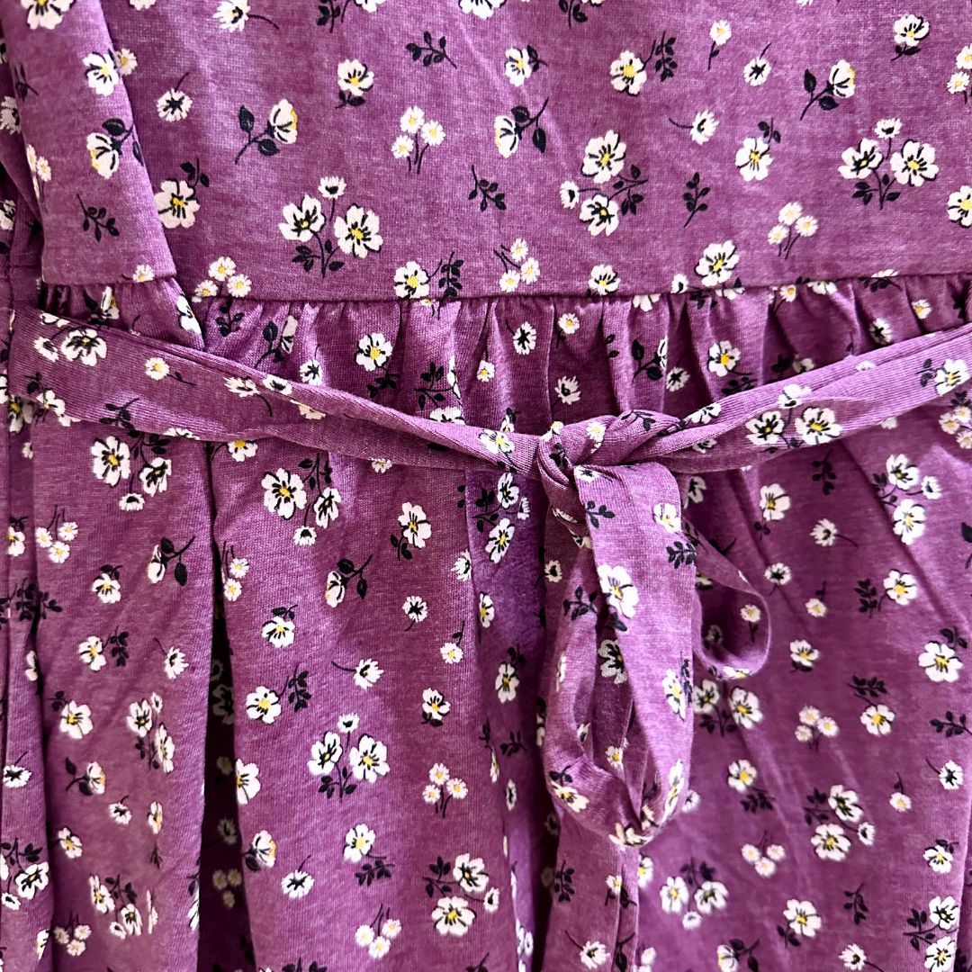 Lilac floral maxi length dress, v neck, puffed elbow length sleeves. Front flap for easy access for breastfeeding and pumping. Ties around back for tightening as needed.