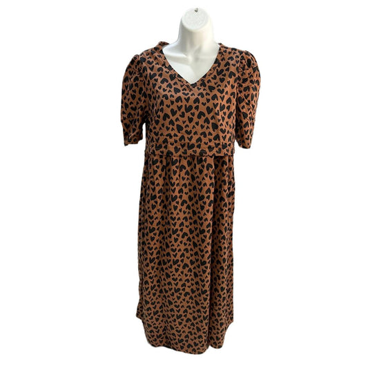 Brown with black small hearts midi length dress, v neck, puffed elbow length sleeves, ties around back to tighten as needed, front flap for easy breastfeeding and pumping access.