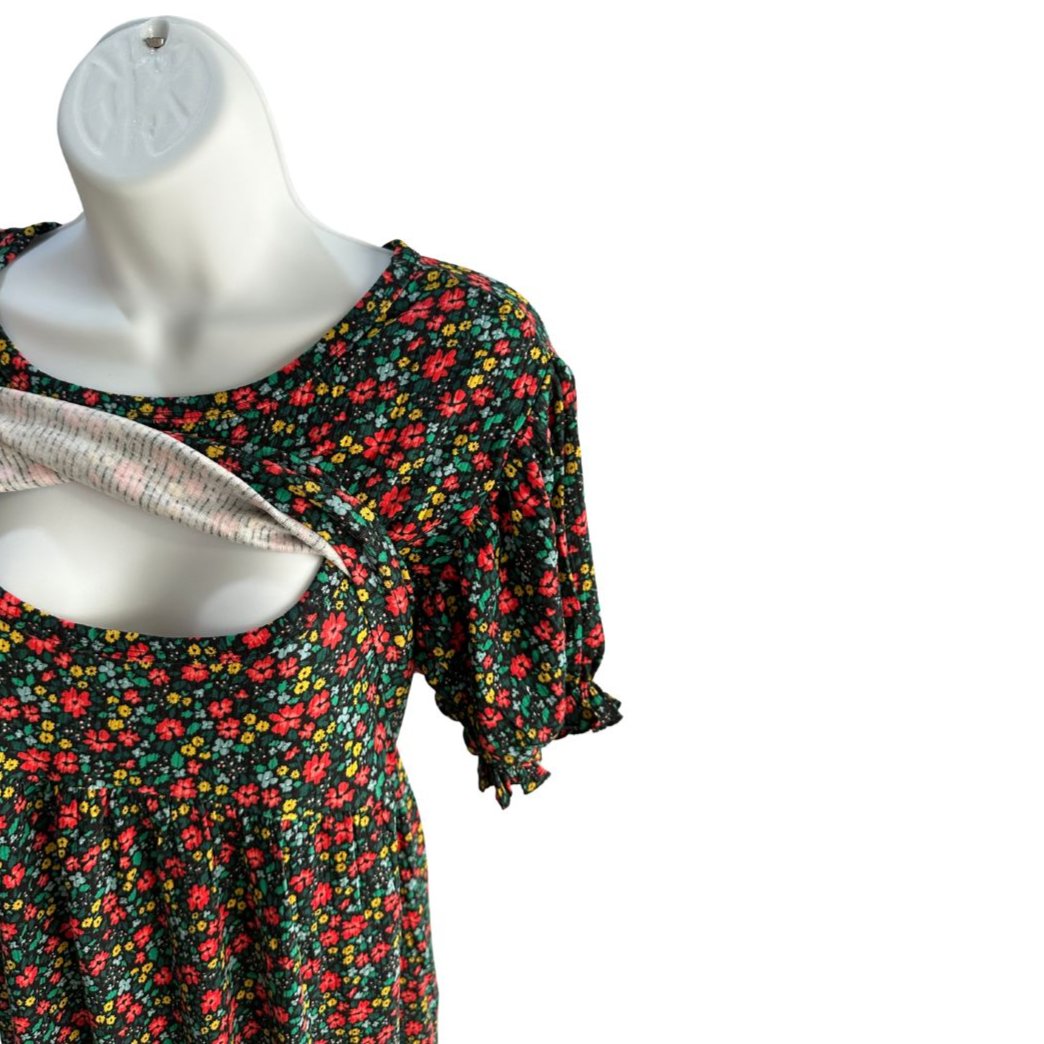 Black midi length dress with red, yellow, and blue floral pattern. Scoop neck, ribbed material, slight puffed short sleeve with scrunched band. Front flap show cased open for easy access for breastfeeding and pumping. Ties around the back to tighten as needed.