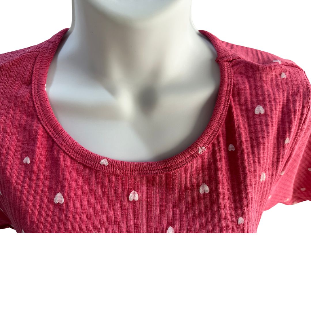 Pink with small white hearts, ribbed material, scoop neck, short sleeves, calf length dress. 